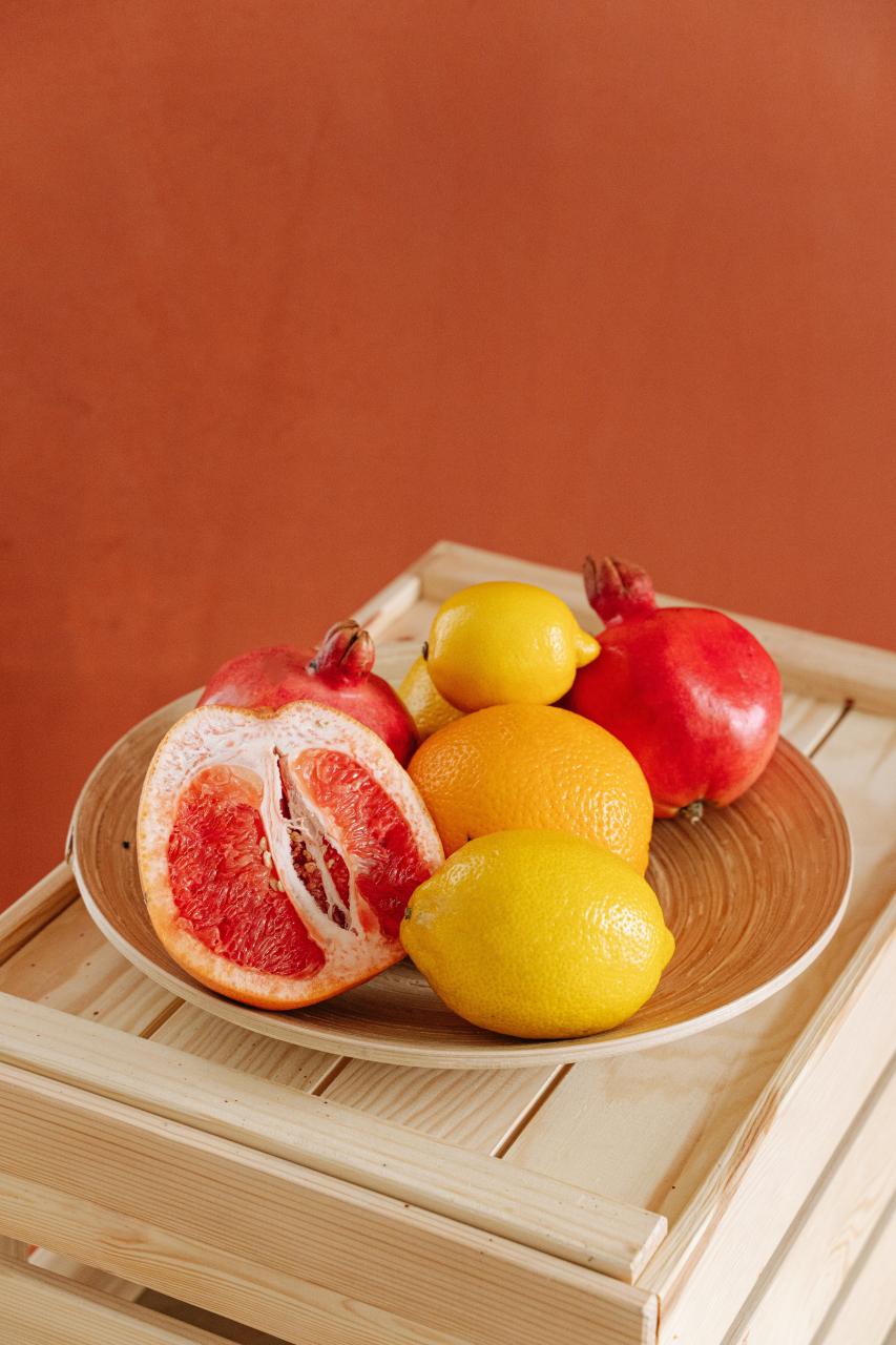 Yellow Citrus Fruit on Brown Wooden Bowl